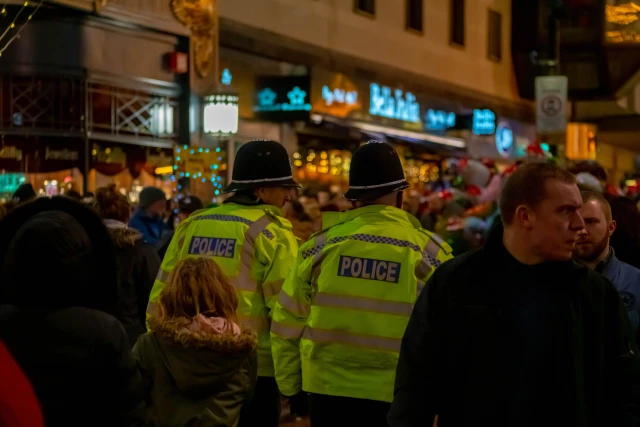 Police on a busy street at night