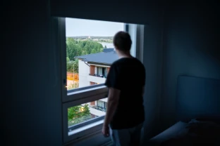 Shadowy figure looking out of a window